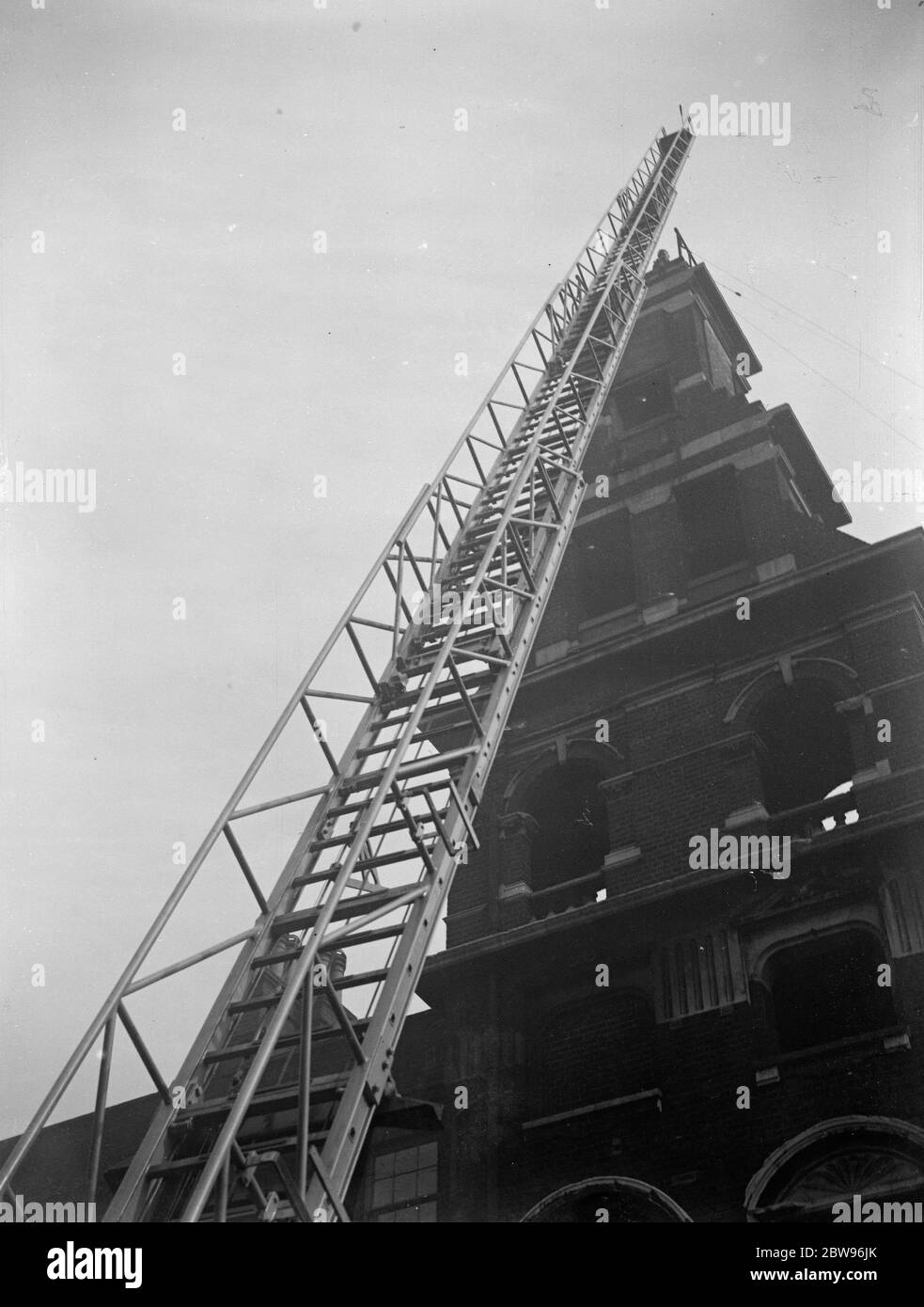 World 's largest fire escape tested by London fire brigade . A turntable fire escape to reach a height of 104 feet , said to be the largest in the world , was tested out by the London fire brigade at their Soutwark headquarters . The new escape was made in Manchester . Testing out the new fire escape at Southwark . 24 March 1932 Stock Photo