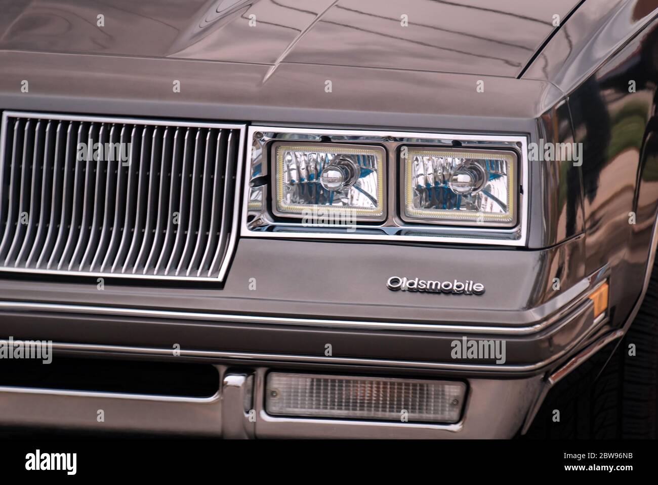 TORONTO, CANADA - 08 18 2018: Front part of exterior with grille, front lights, logo of 1984 Oldsmobile Cutlass Supreme oldtimer car made by General Stock Photo
