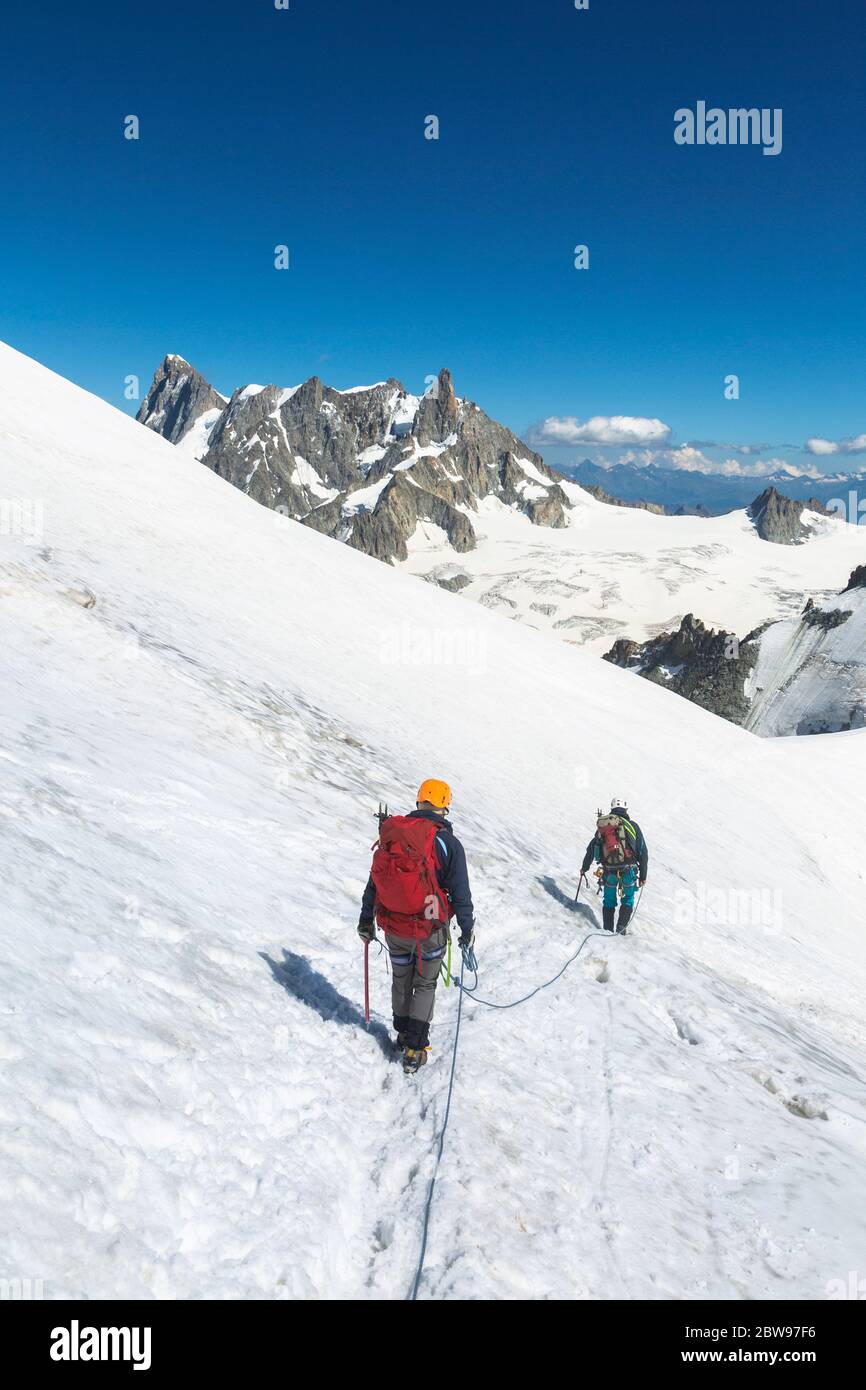 Alpinists with rope and climbing tools on Col du Midi in front of Grandes Jorasses, Mont Blanc massif in the French Alps, Chamonix Mont-Blanc, France Stock Photo