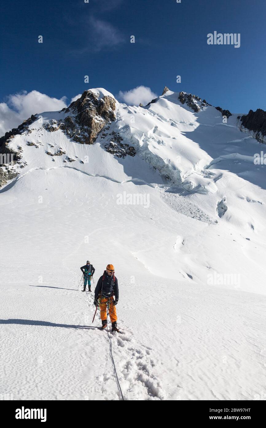 Chamonix-Mont-Blanc, France - August 04, 2019: Alpinists on the Mont Blanc three mounts route over Mont-blanc du Tacul, Mont Maudit and the main Alps Stock Photo