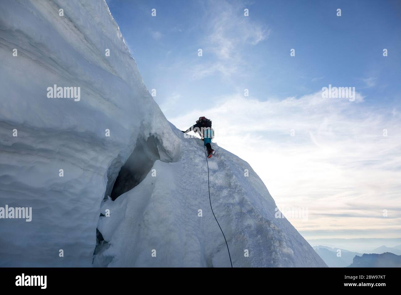Alpinist climbs Mont-blanc du Tacul ( three mounts route, par les 3 monts) in the French Alps, Chamonix-Mont-Blanc, France Stock Photo