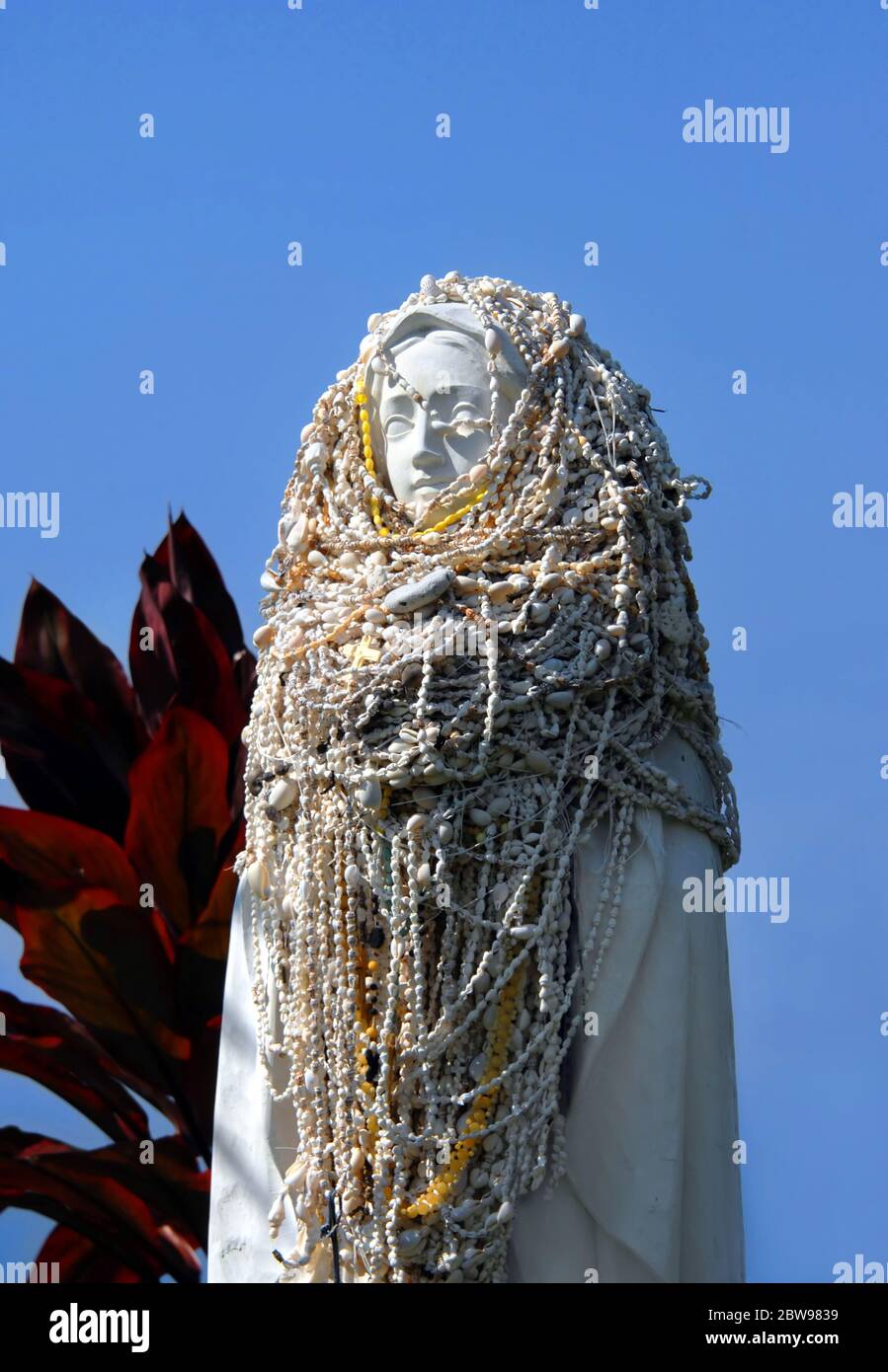 Holy Mary Shell Statue of Virgin Mary is covered in shell necklaces at St. Benedicts ...