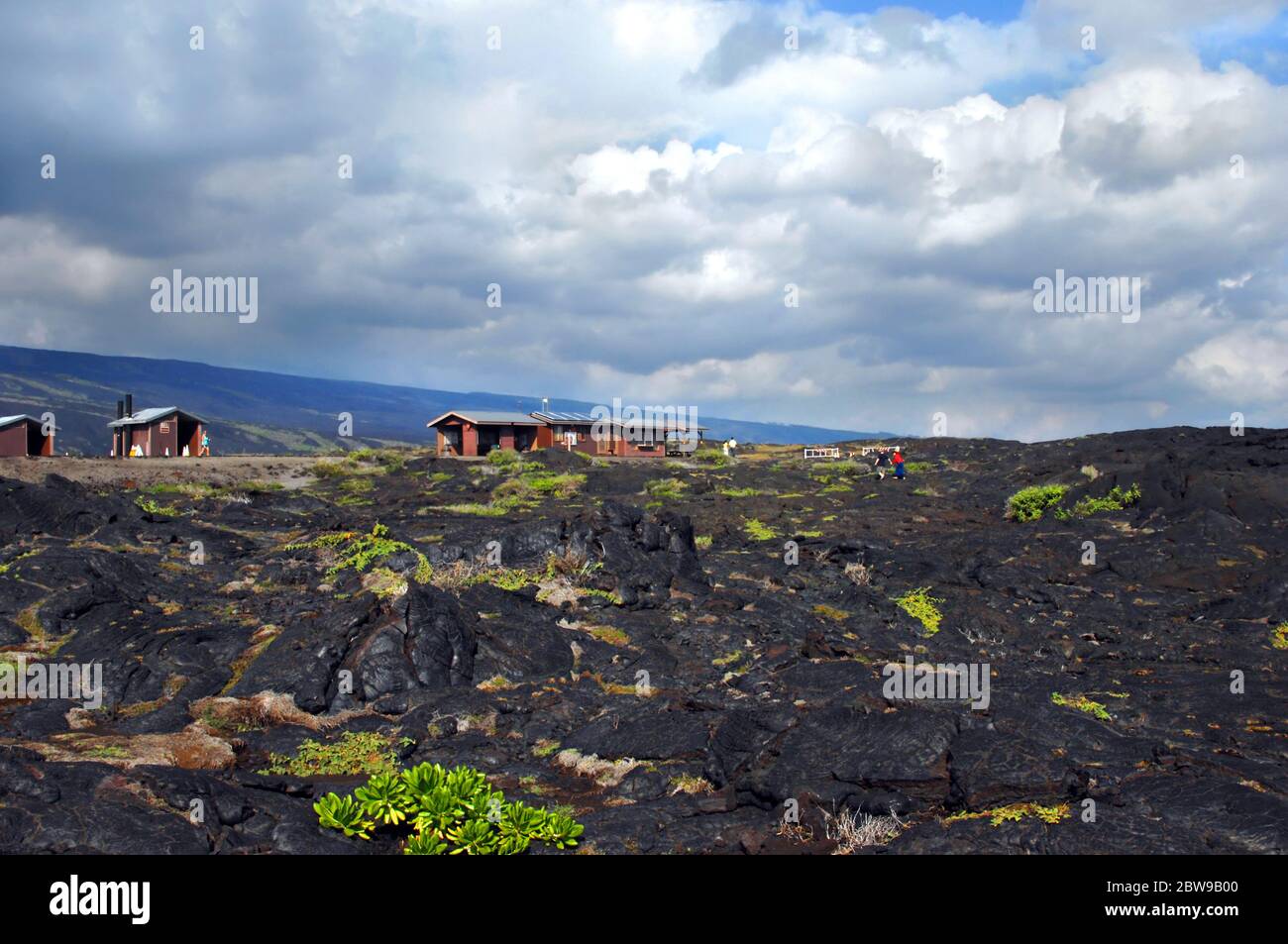 Kilheaua Volcano has filled with sky with vog as it continues to be active.  Visitors explore the lava field at the end of Chain of Craters Road in Ha Stock Photo