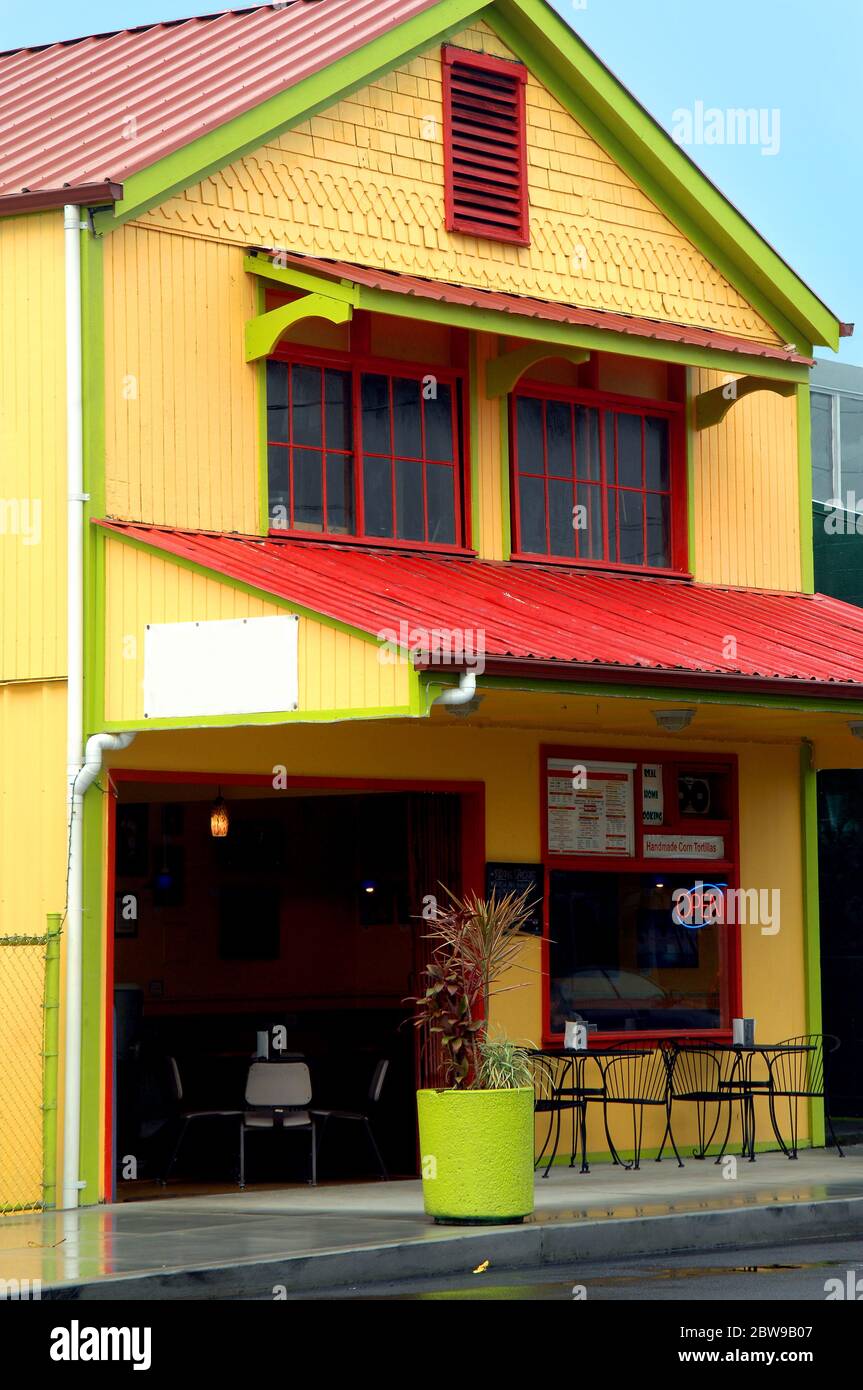 Downtown Hilo, Hawaii has restored buildings open for business.  This restaurant is an eye catcher with yellow painted gingerbread trim with highlight Stock Photo