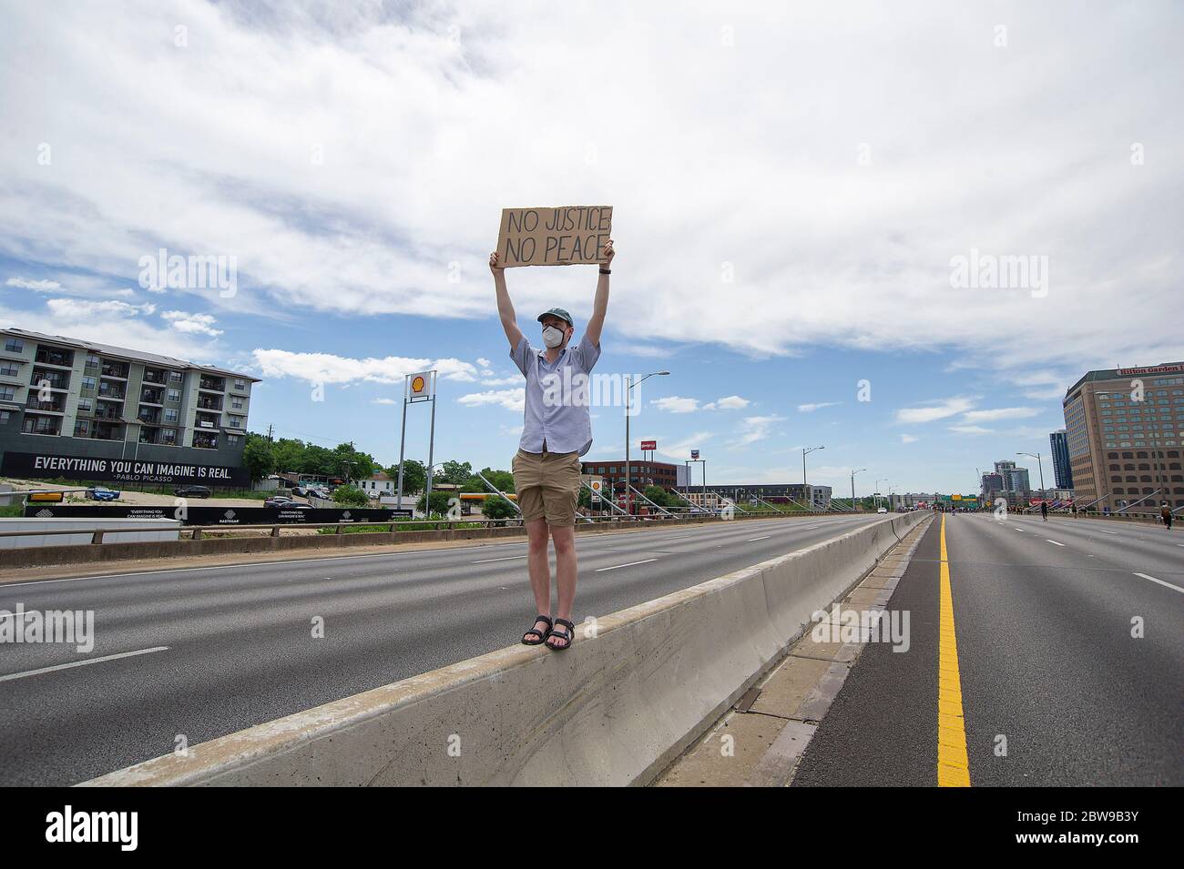 Him. 30th May, 2020. Marshall Geyer holds a sign 'No Justice, No Peace'' while traffic was stopped on Interstate 35 during the Mike Ramos protest in Austin. A month ago Mike Ramos died after an officer fired his rifle at him. Austin, Texas. Mario Cantu/CSM/Alamy Live News Stock Photo