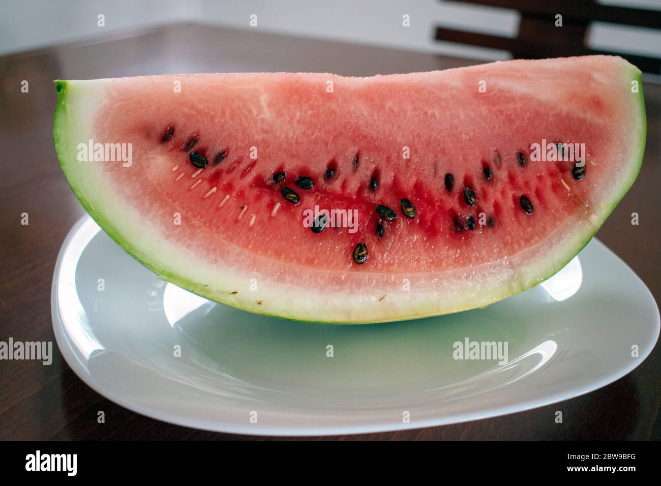 Watermelon in white plate on wood table Stock Photo