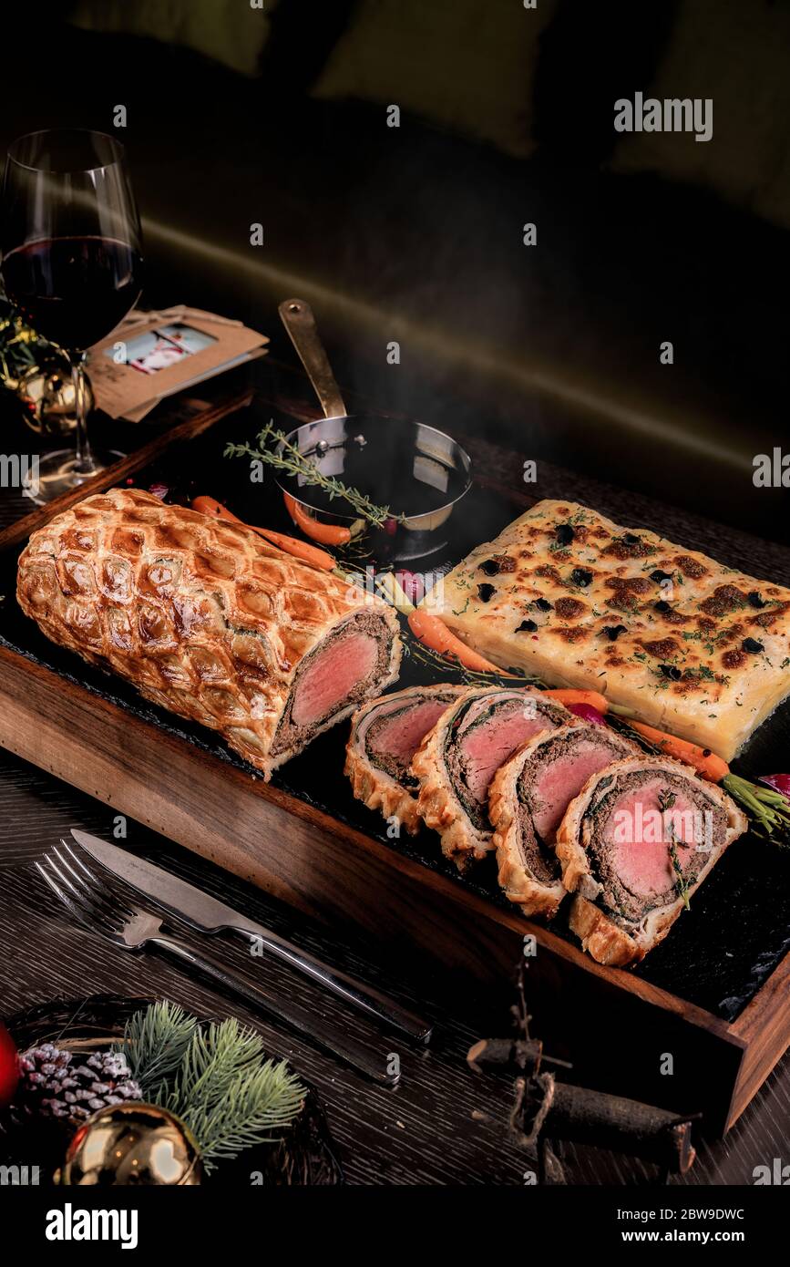 Fresh homemade beef wellington in flaky puff pastry dough hires stock