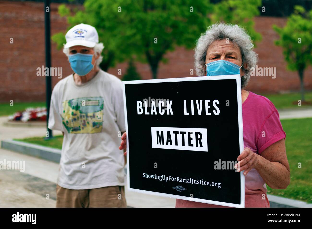 Protesters With Face Masks Hold A Black Lives Matter Sign Stock Photo
