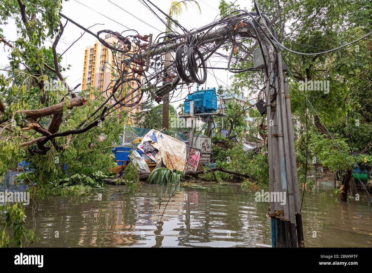 High tension electric wires hanging dangerously from a broken pole on a
