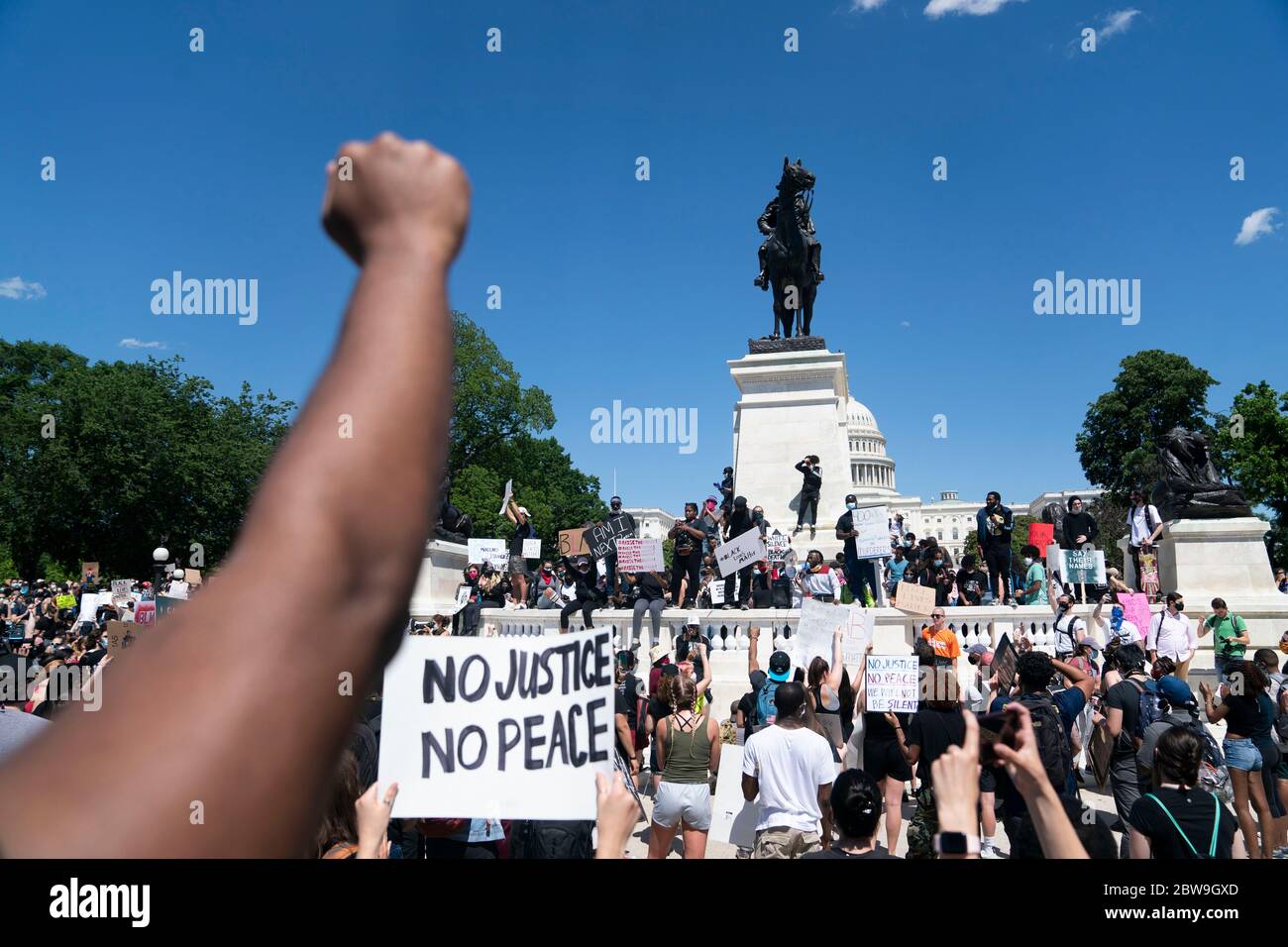 Washington, DC, USA. 30th May, 2020. Protesters rally near the Capitol Building during a protest over the death of George Floyd in Washington, DC, the United States, on May 30, 2020. Demonstrations and riots have spread to cities across the United States after a video went viral of George Floyd being suffocated to death by a white police officer in the midwest U.S. state of Minnesota on May 25. Credit: Liu Jie/Xinhua/Alamy Live News Stock Photo