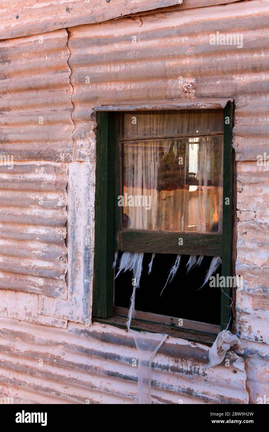 Wood framed window on a Corrugated iron house  of the historical gold mining town Gwalia, Leonora, Western Australia Stock Photo