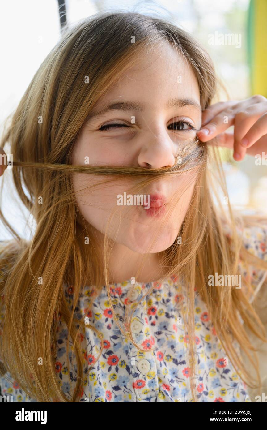 Portrait of girl (6-7) making funny faces Stock Photo