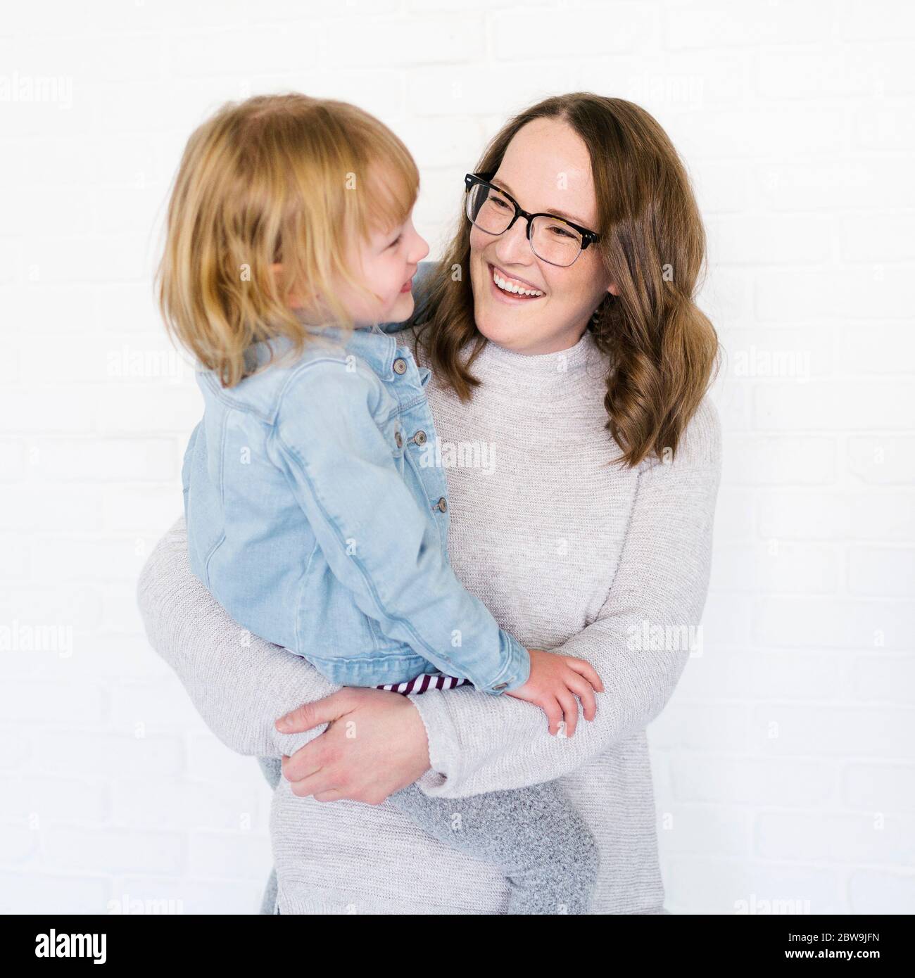 Mother holding daughter (6-7) Stock Photo