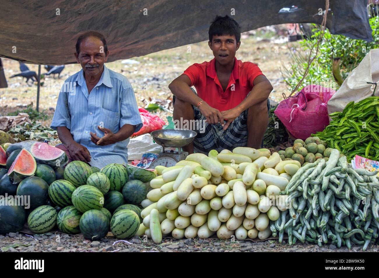 Men selling a variety of fresh fruit and vegetables at a roadside market at Mirissa in southern Sri Lanka. Stock Photo