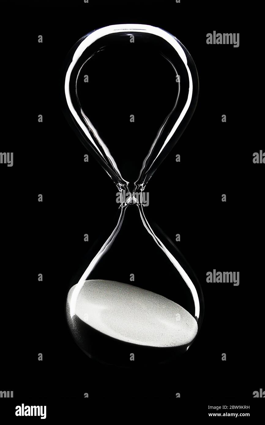 Hour glass on black background Stock Photo Alamy