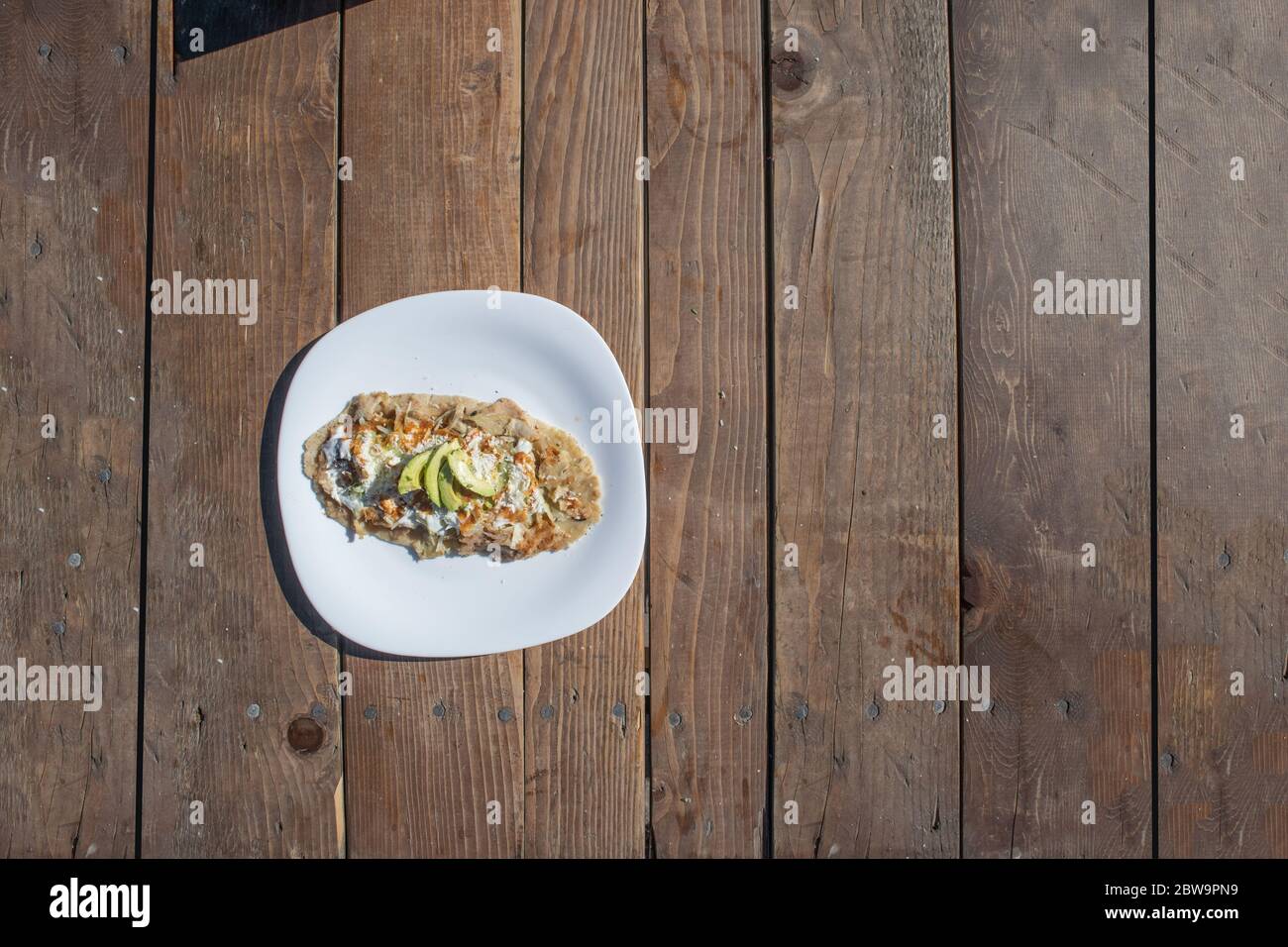 Top View Of Huarache Mexican Food Dish With Sauce Meat And Avocado Stock Photo Alamy