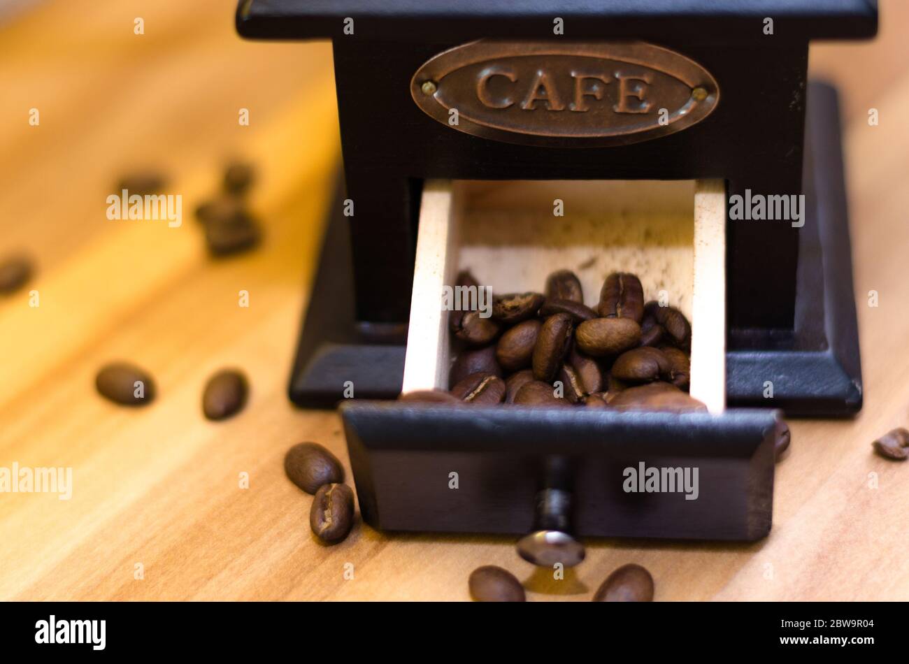 A coffee drawer from a coffee grinder with half of its capacity full of