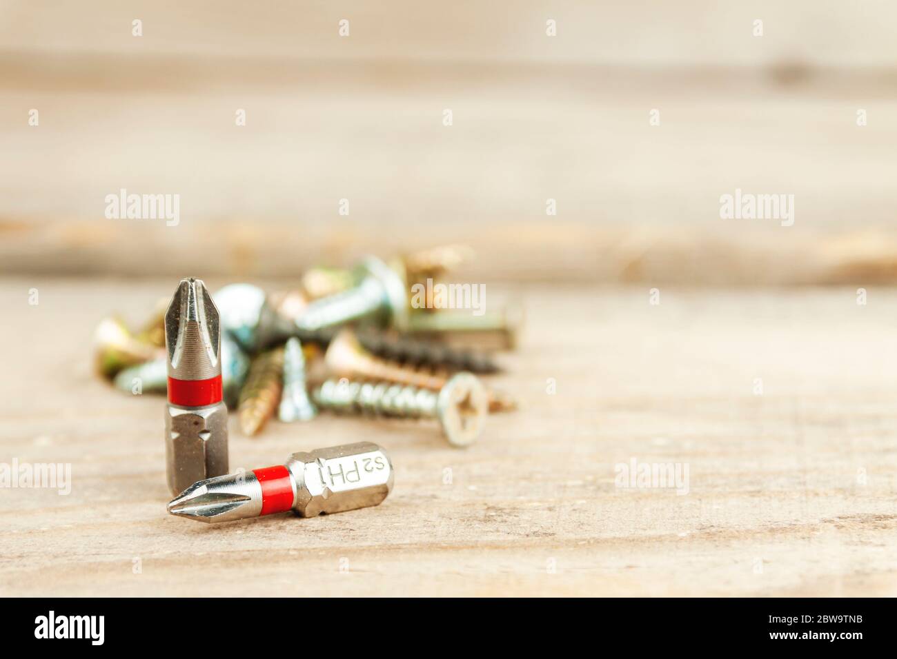Two bits on the background of screws Stock Photo