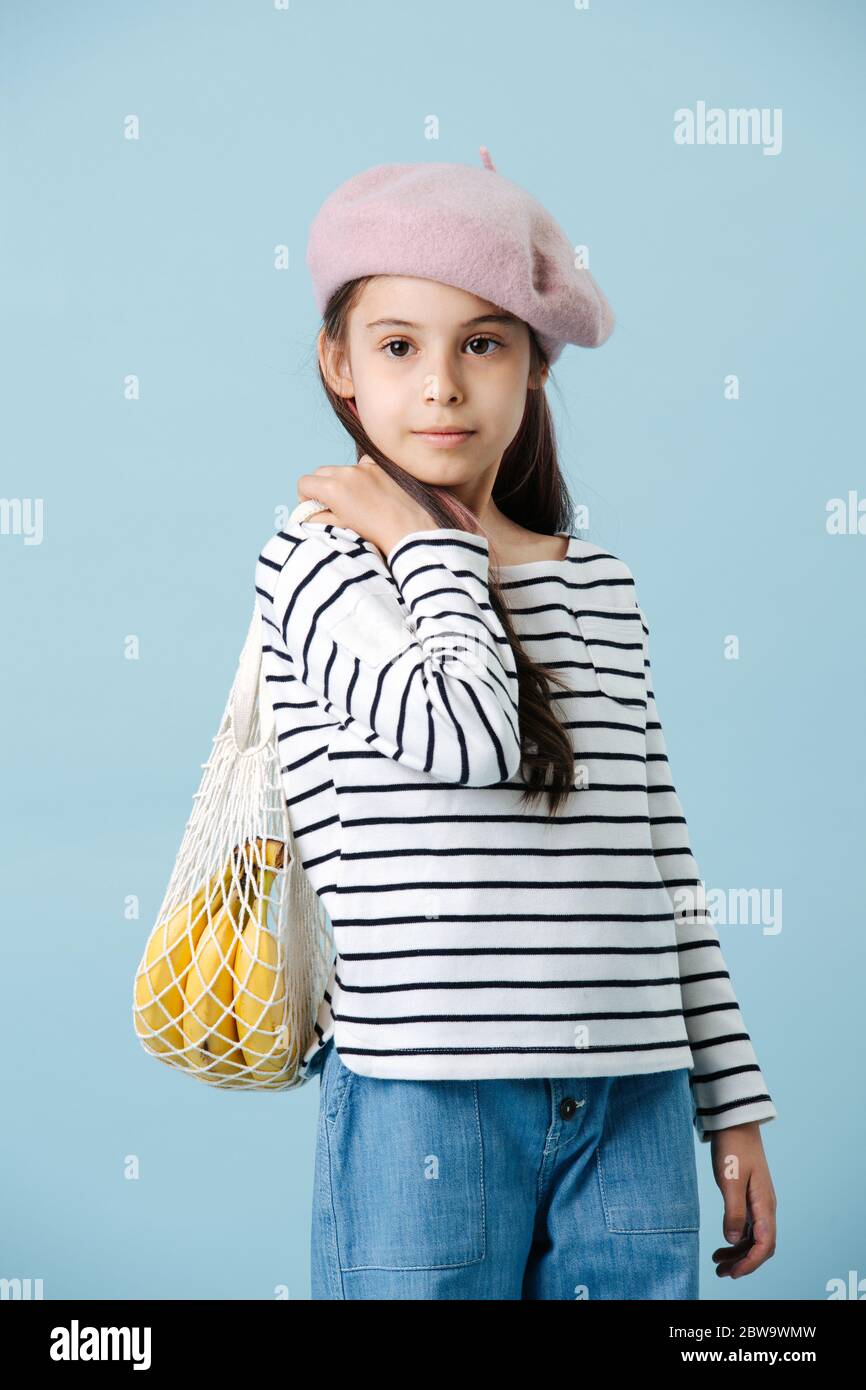 Portrait of a fashionable little girl in french beret holding bag with bananas Stock Photo Alamy