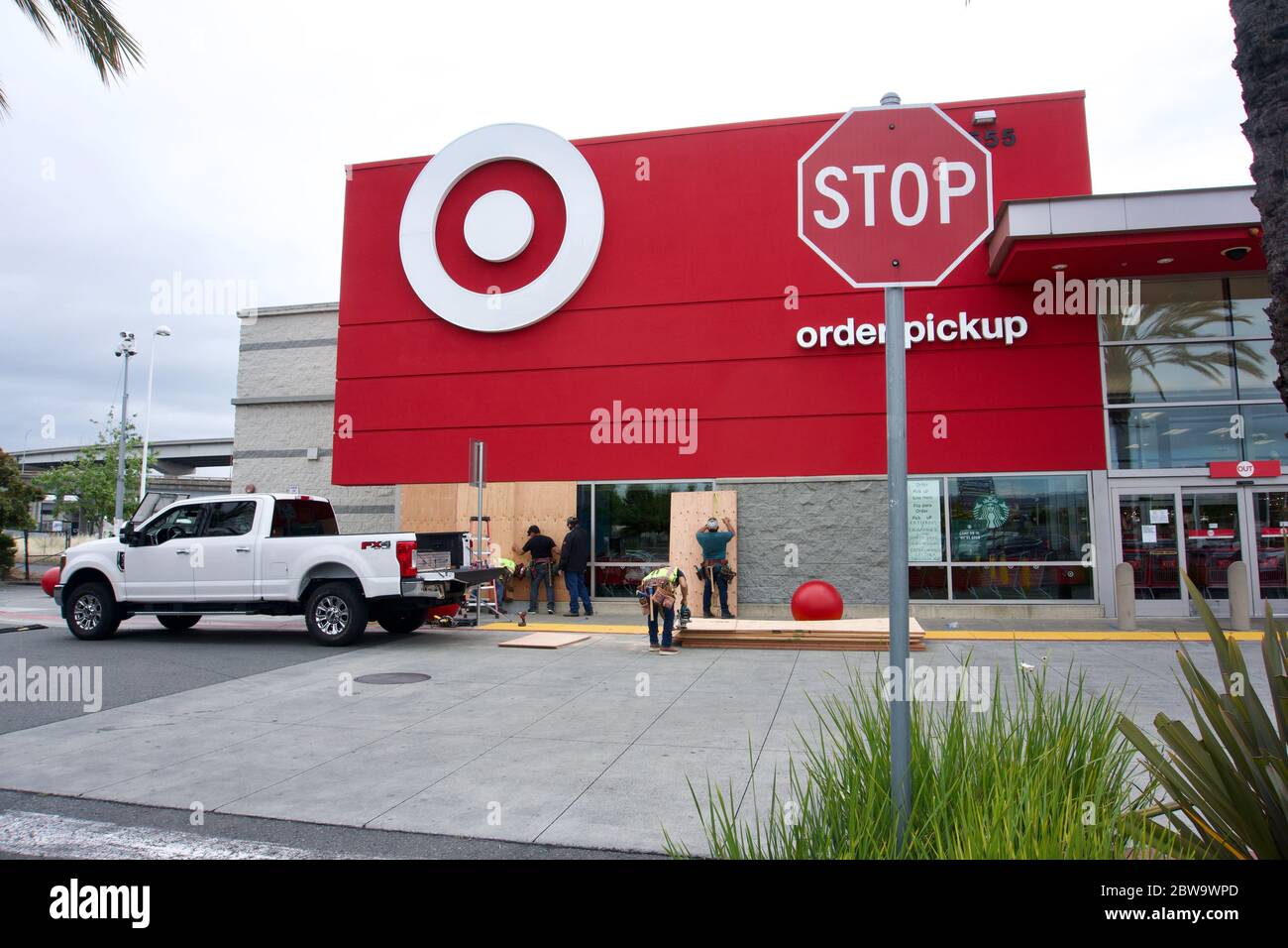 Workers board up Target store windows to safeguard against looters after the killing of George Floyd by a police officer. Oakland, CA Stock Photo