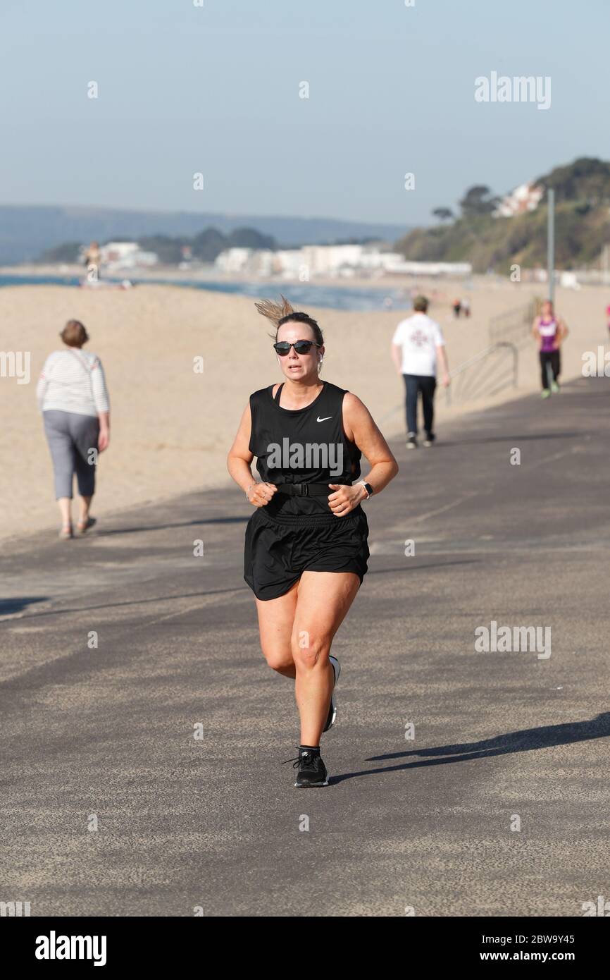 Poole, UK. 31st May 2020.    Early risers taking exercise at  Branksome Chine beach in Poole, Dorset. Credit: Richard Crease/Alamy Live News Stock Photo