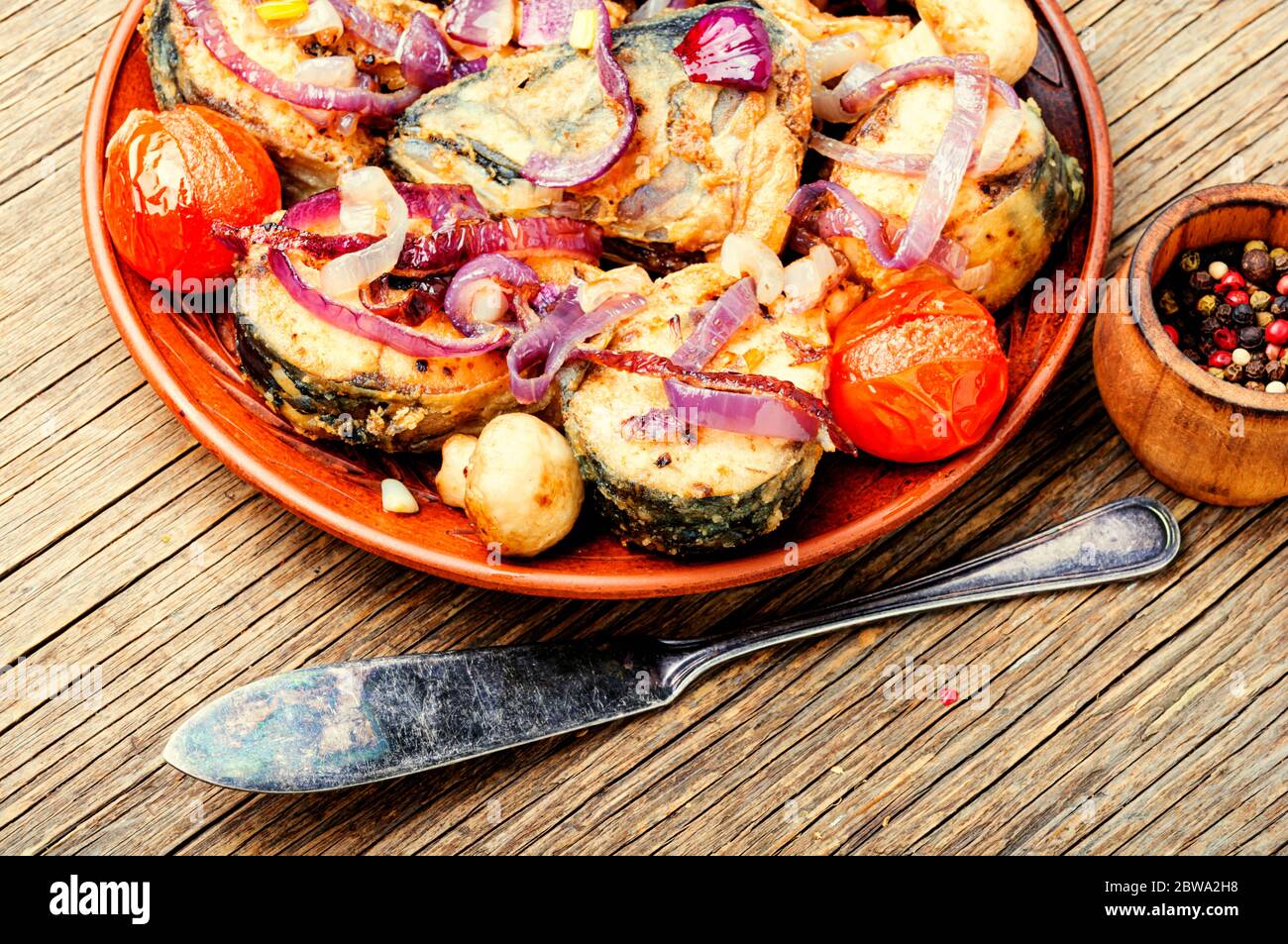 Fried mackerel with grilled vegetables on plate.Roast fish Stock Photo