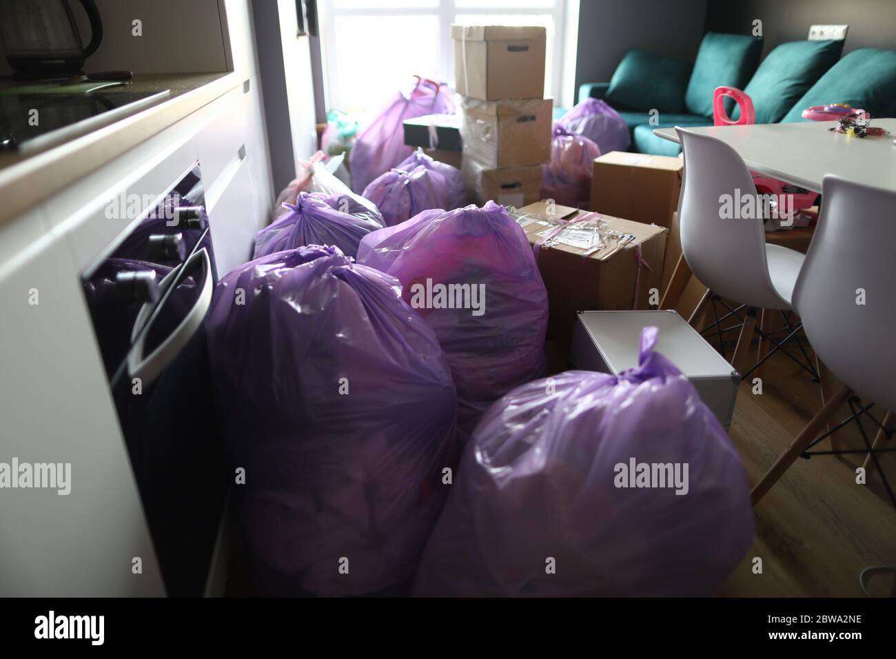 Kitchen is full garbage bags and cardboard boxes Stock Photo