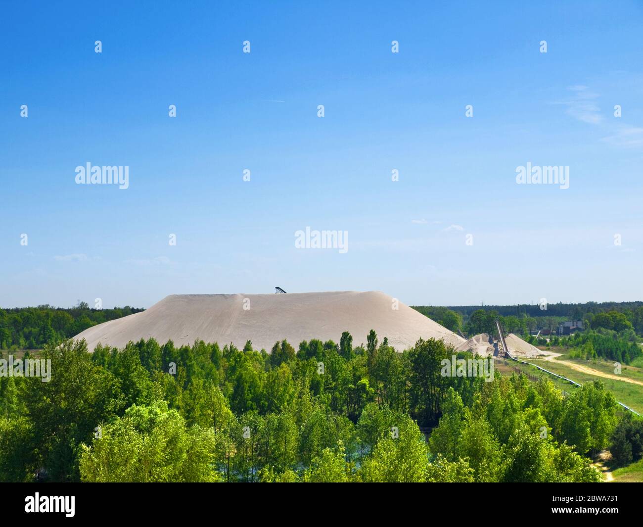 long distance shot of sand mine mountain in the forest Stock Photo
