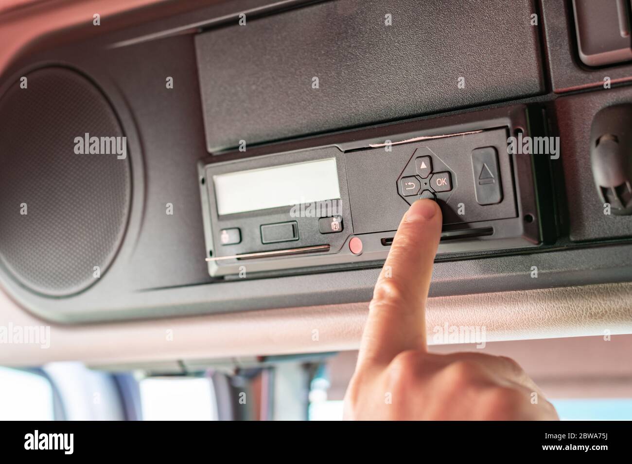 Truck driver performing driver card and menu operations on the