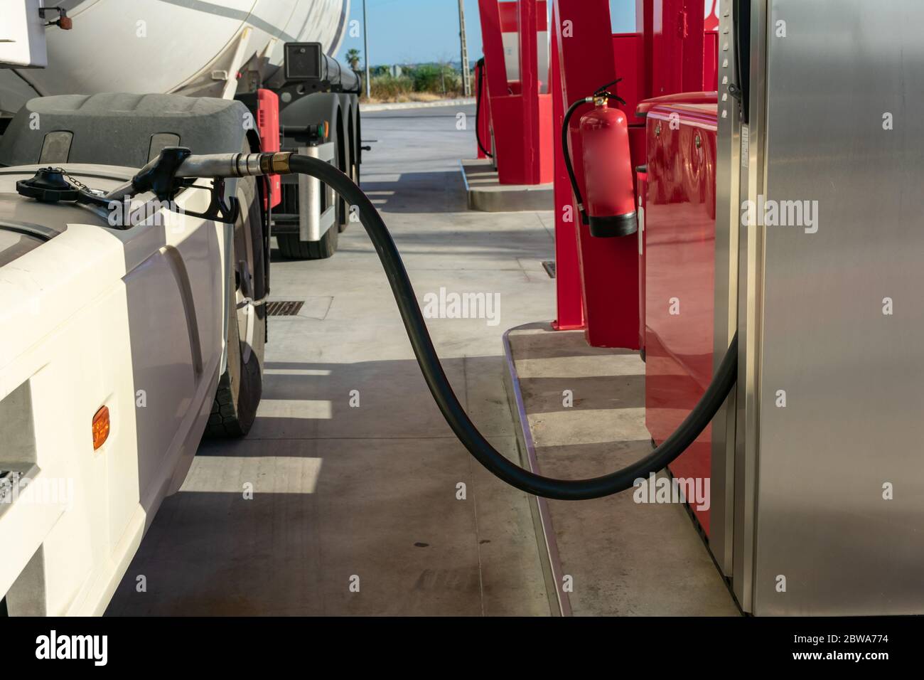 Tank truck refueling at a service station with the nozzle placed in the  fuel tank Stock Photo - Alamy