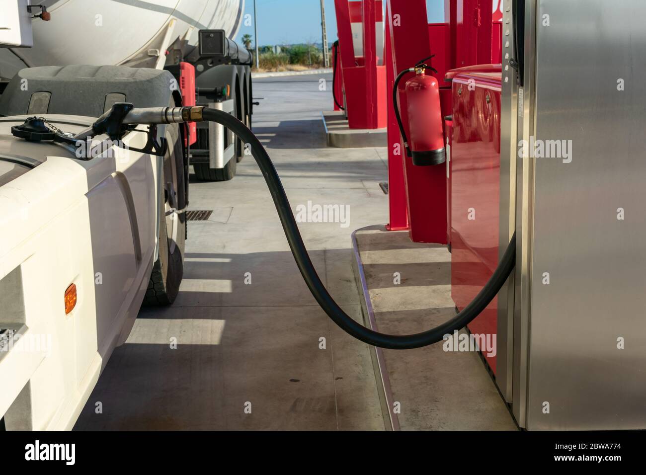 Tank truck refueling at a service station with the nozzle placed in the ...