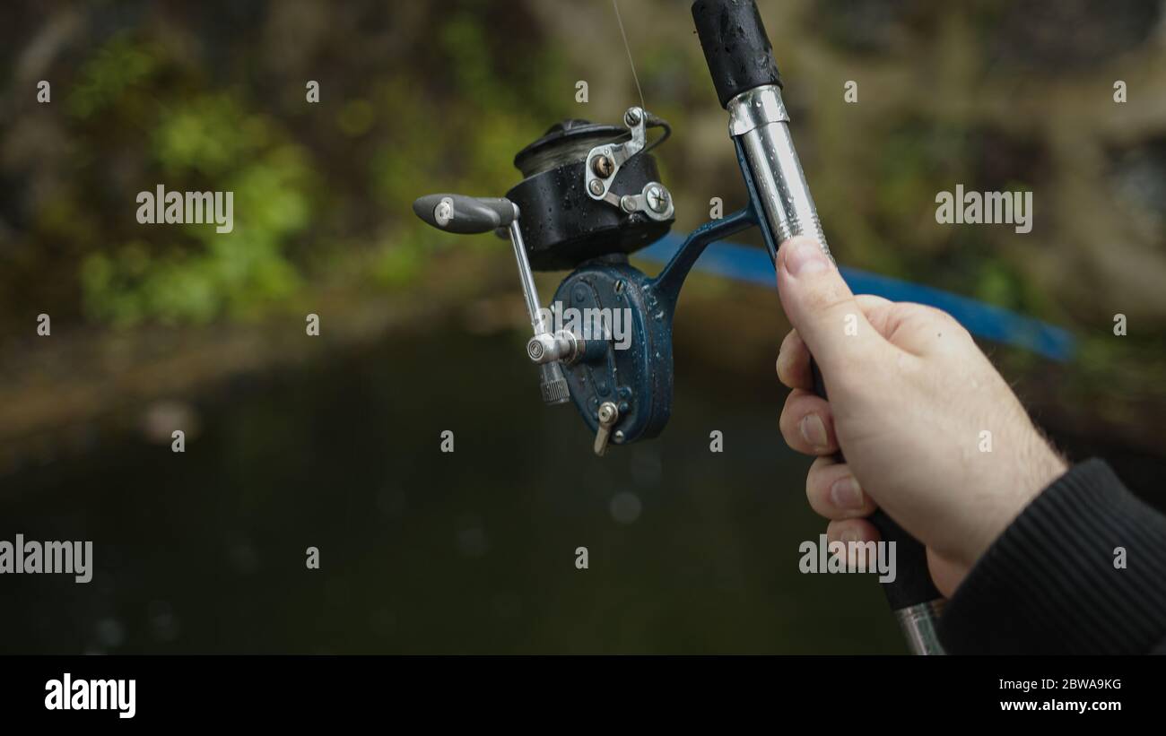 Fishing rod and hand close-up Stock Photo