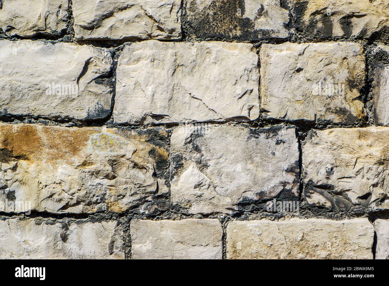 a cracked real stone wall surface Kendal Stock Photo