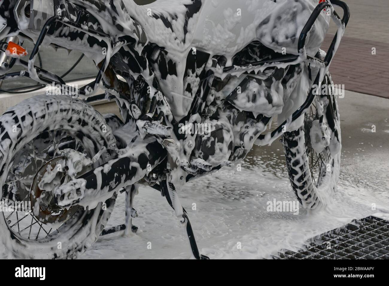 Motorcycle washing with cleaning foam. Pure moto bike. Enduro