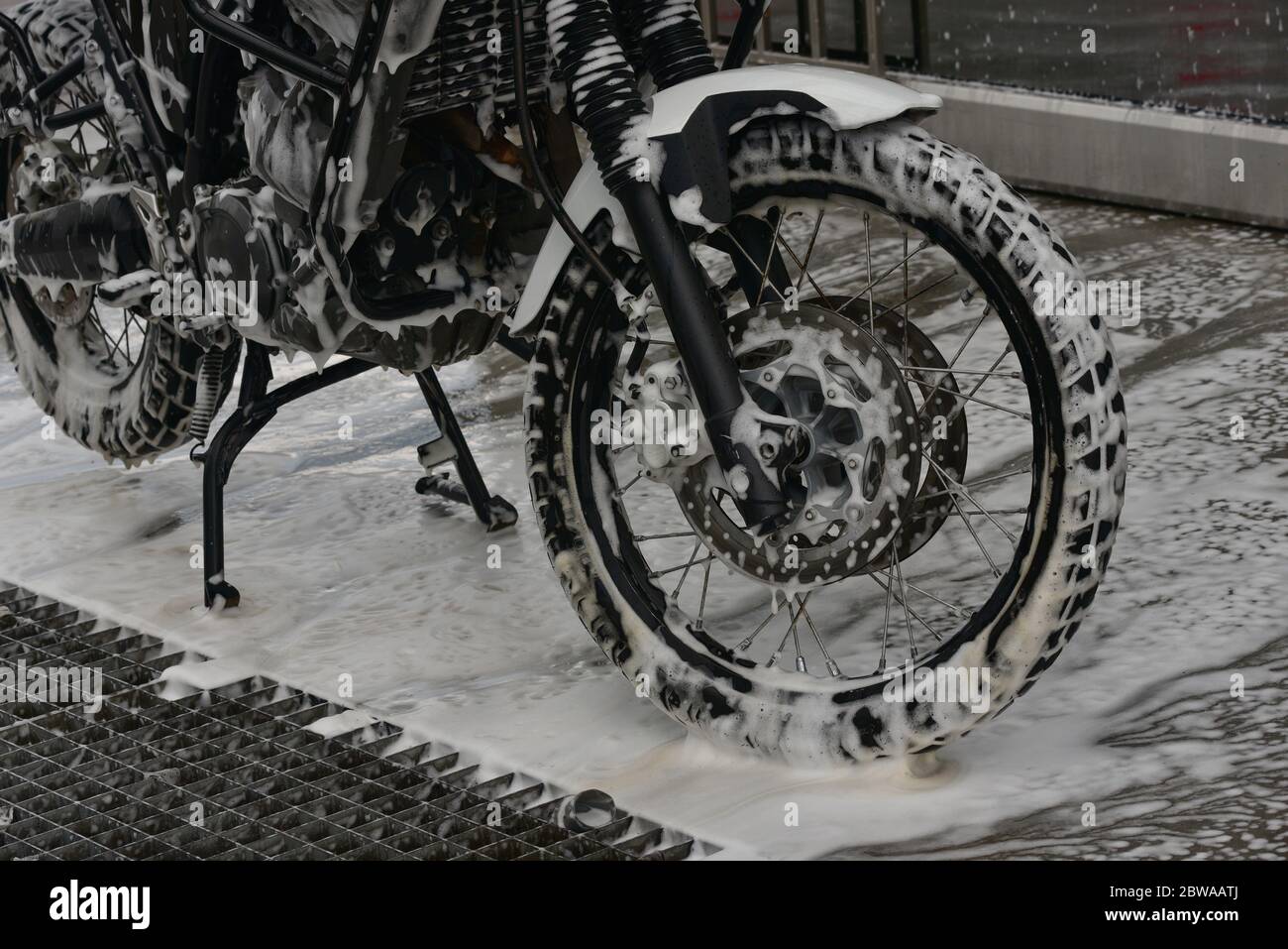 Motorcycle washing with cleaning foam. Pure moto bike. Enduro motorcycle.  Cleanliness of vehicles. Car wash professional Stock Photo - Alamy