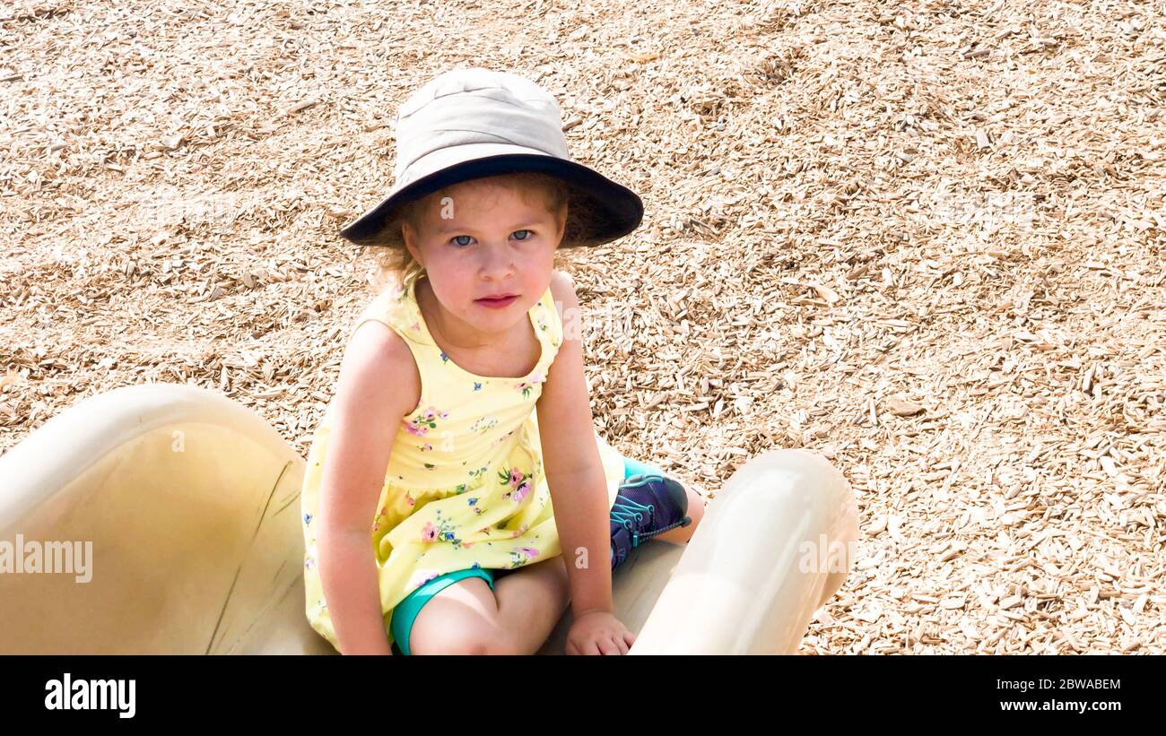 Little girl playing at the kids playground on the hot summer day Stock ...