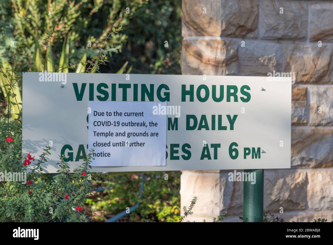 A sign at the entrance to the Bahai Temple in Terrey Hills, Sydney, Australia is covered with a Covid-19 closed notice. Stock Photo