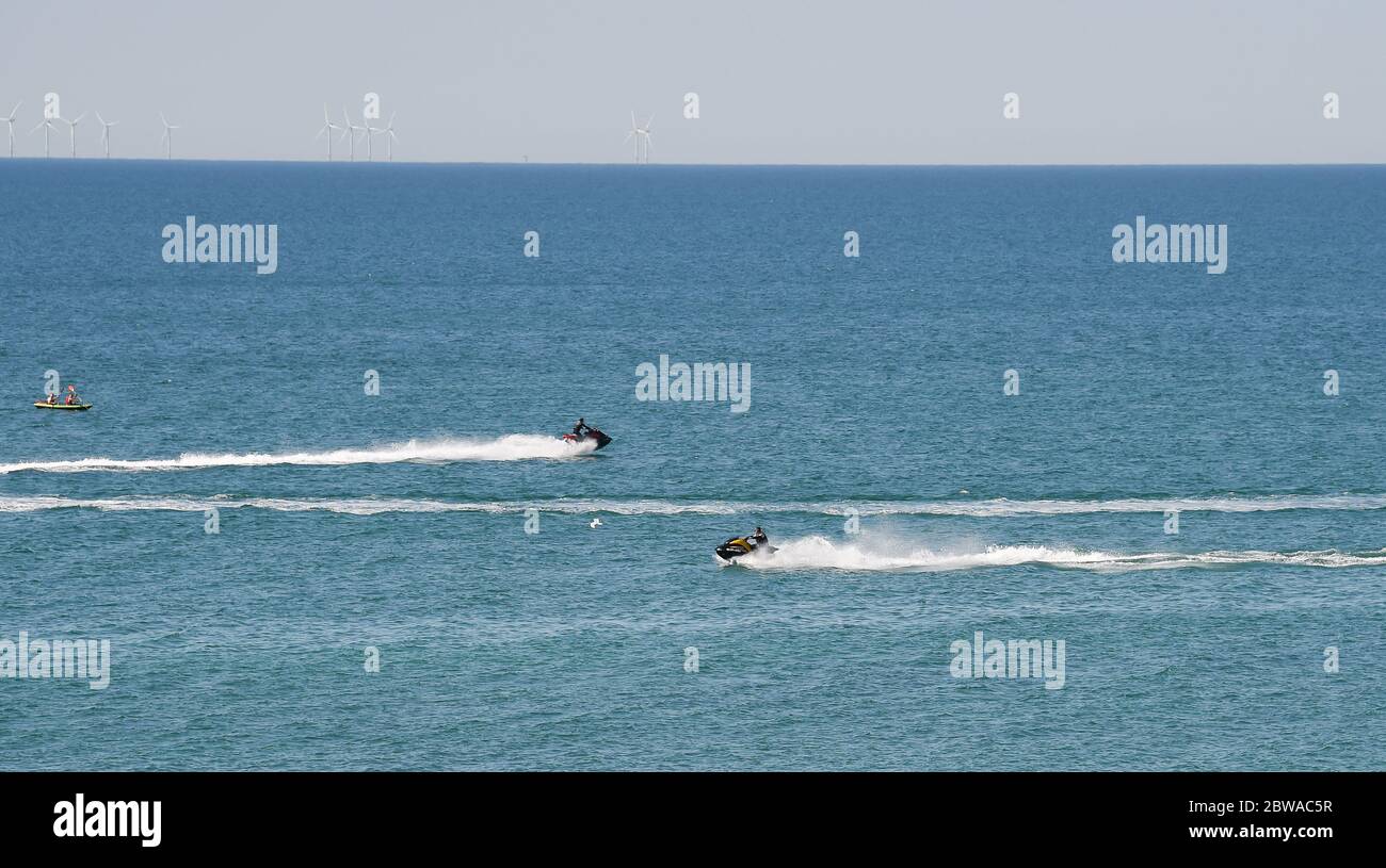 Brighton UK 31st May 2020 - Jet skiers off Brighton beach on another beautiful sunny day during the Coronavirus COVID-19 pandemic crisis  . Credit: Simon Dack / Alamy Live News Stock Photo