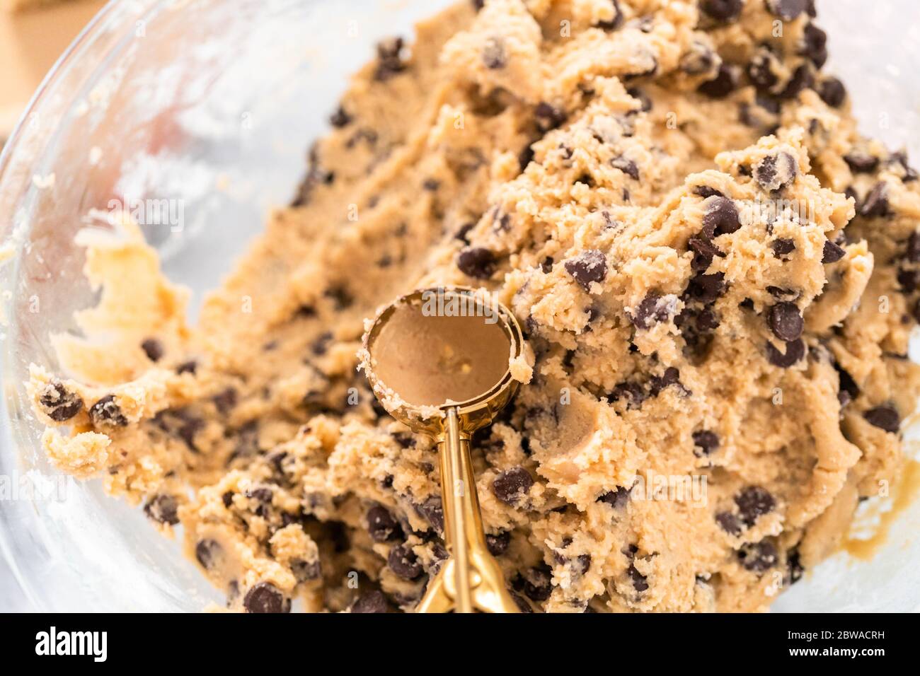 Homemade cookie dough with chocolate chips in a glass mixing bowl Stock ...