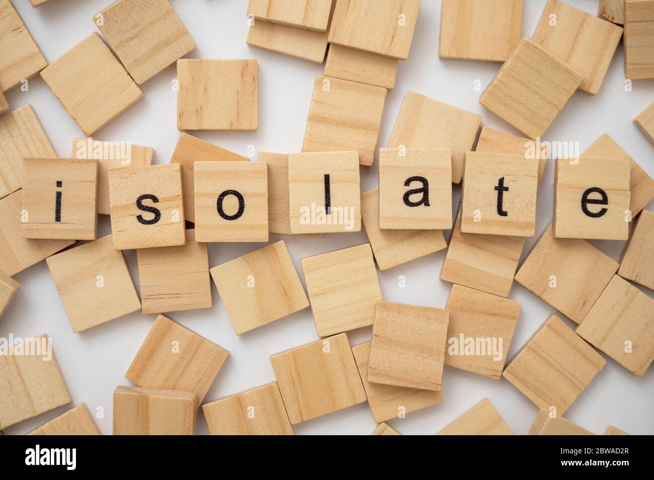Wooden letter tiles spelling the word ISOLATE Stock Photo