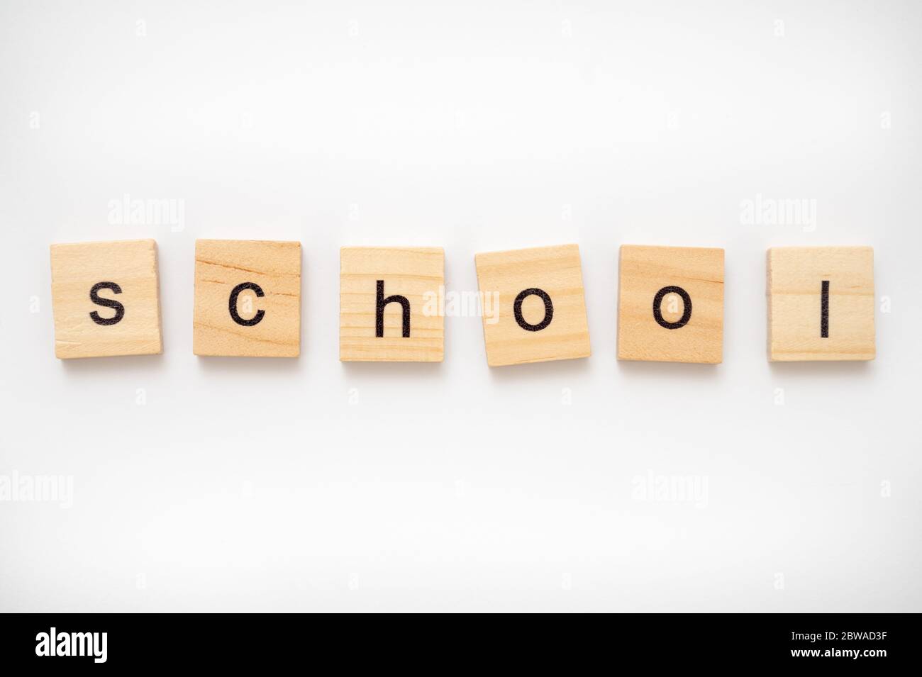 Wooden letter tiles spelling the word SCHOOL Stock Photo