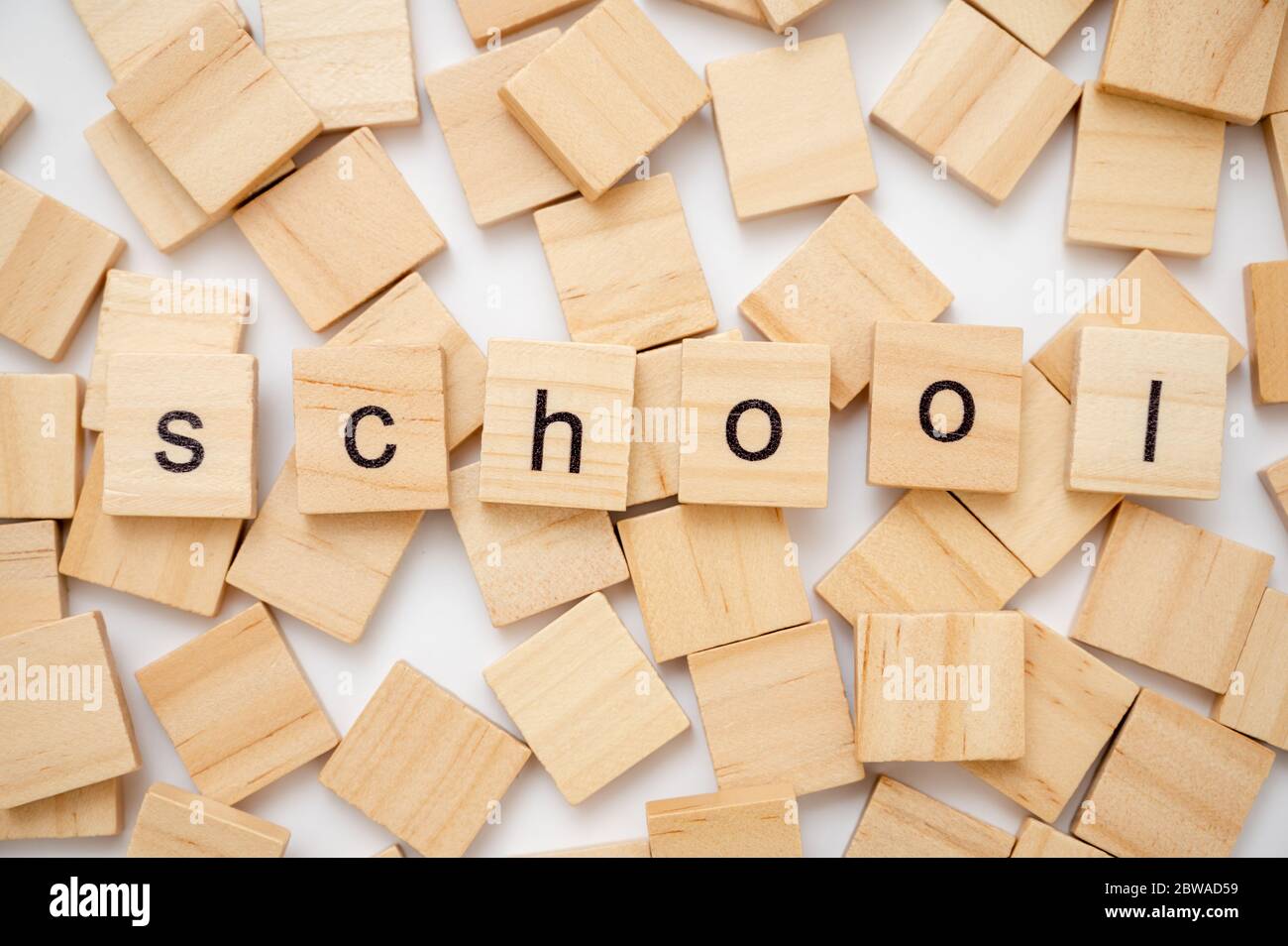Wooden letter tiles spelling the word SCHOOL Stock Photo