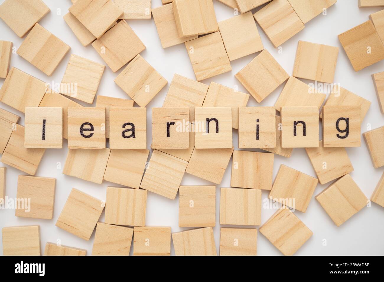Wooden letter tiles spelling the word LEARNING Stock Photo