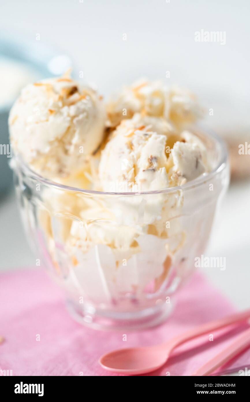 Preparing homemade coconut ice cream with roasted coconut flakes Stock Photo Alamy