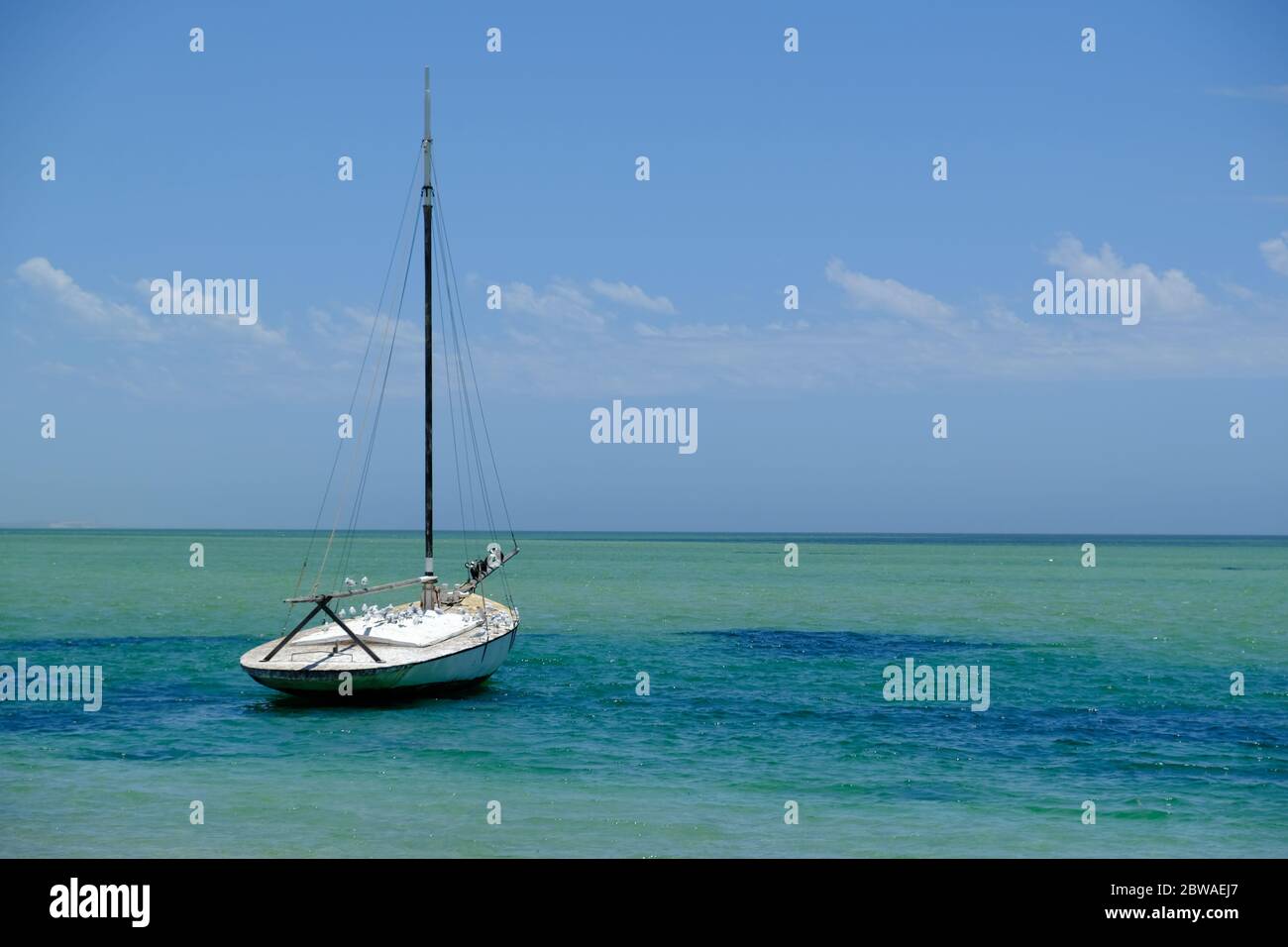 Western Australia Shark Bay - Denham Costline and sailing boat Stock Photo