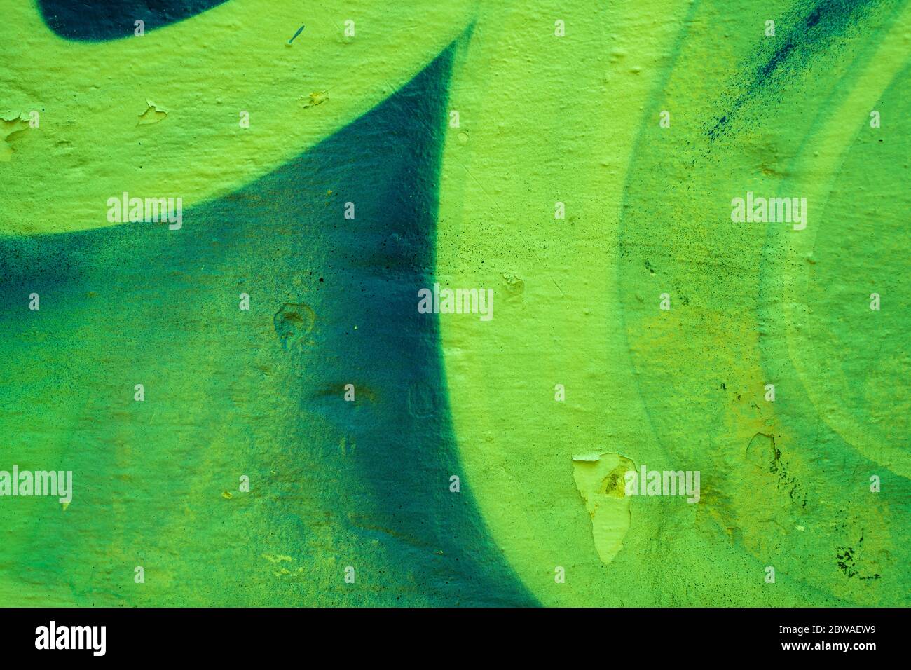 Green abstract gradient paint on a colorful wall. Close-up of a graffiti texture. Street art background. Stock Photo