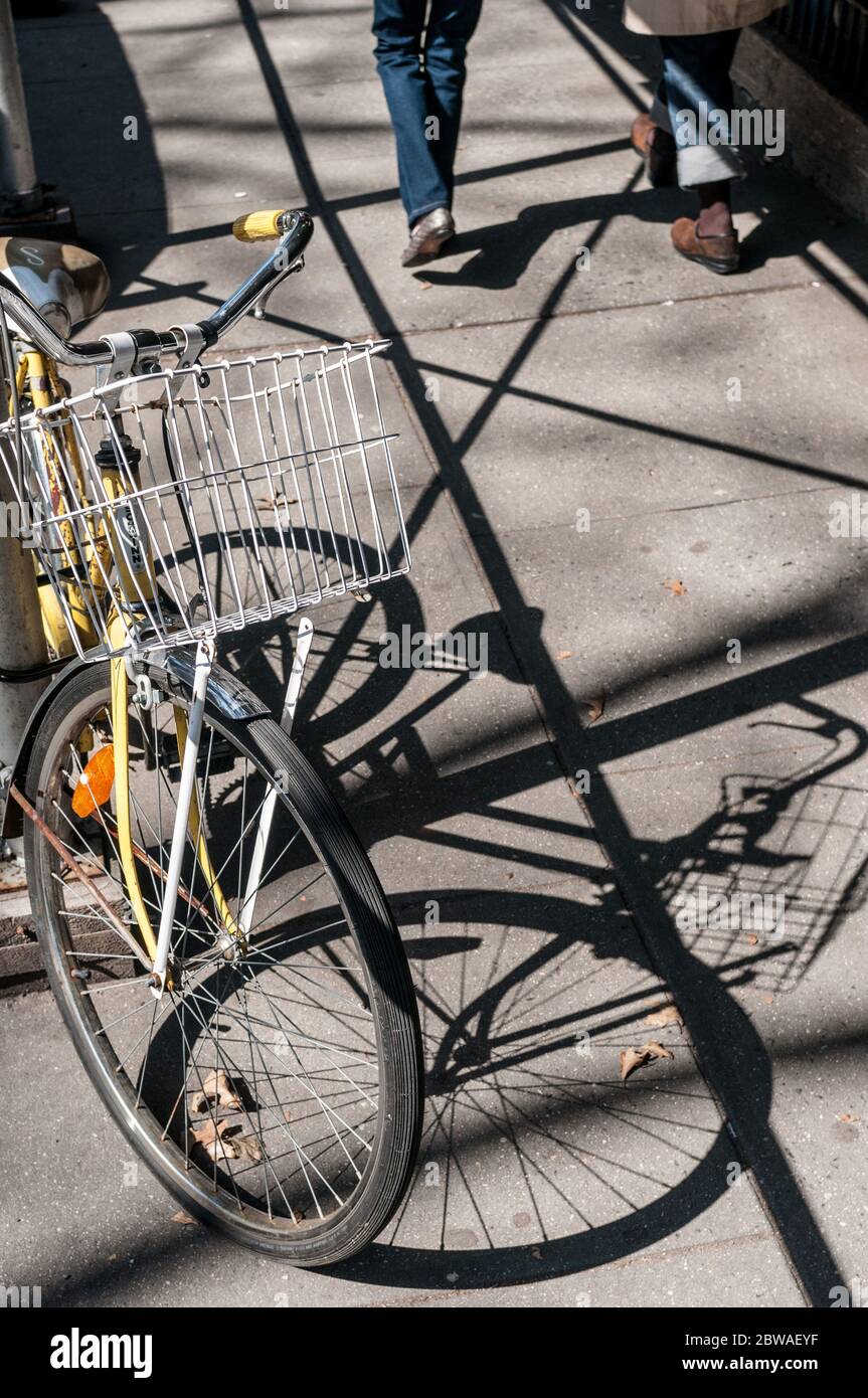 Bicycle locked to pole on sidewalk, Brooklyn, New York, USA Stock Photo
