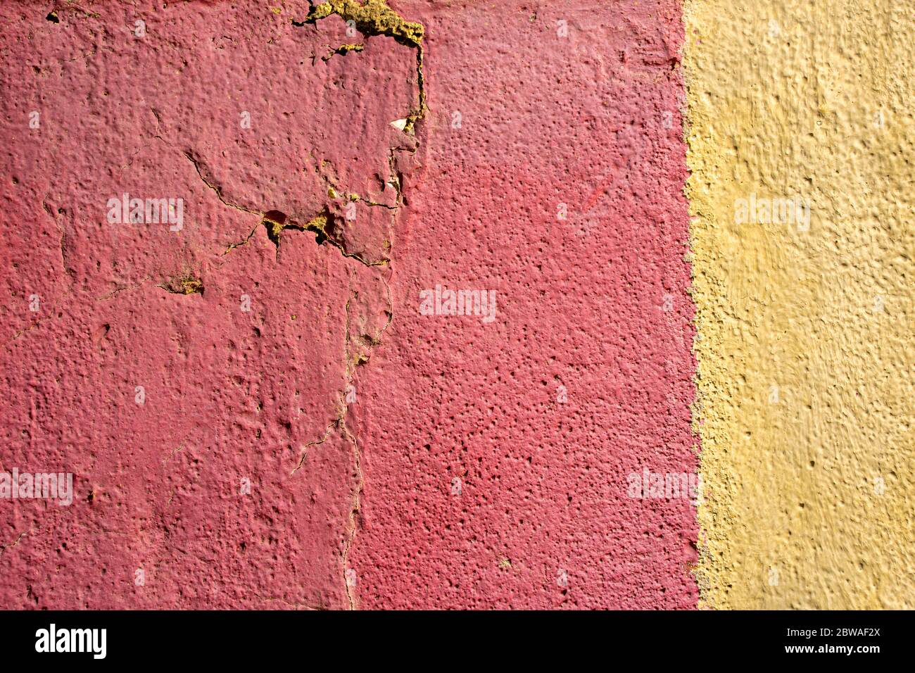 Red and yellow rough stucco wall texture cracked Stock Photo