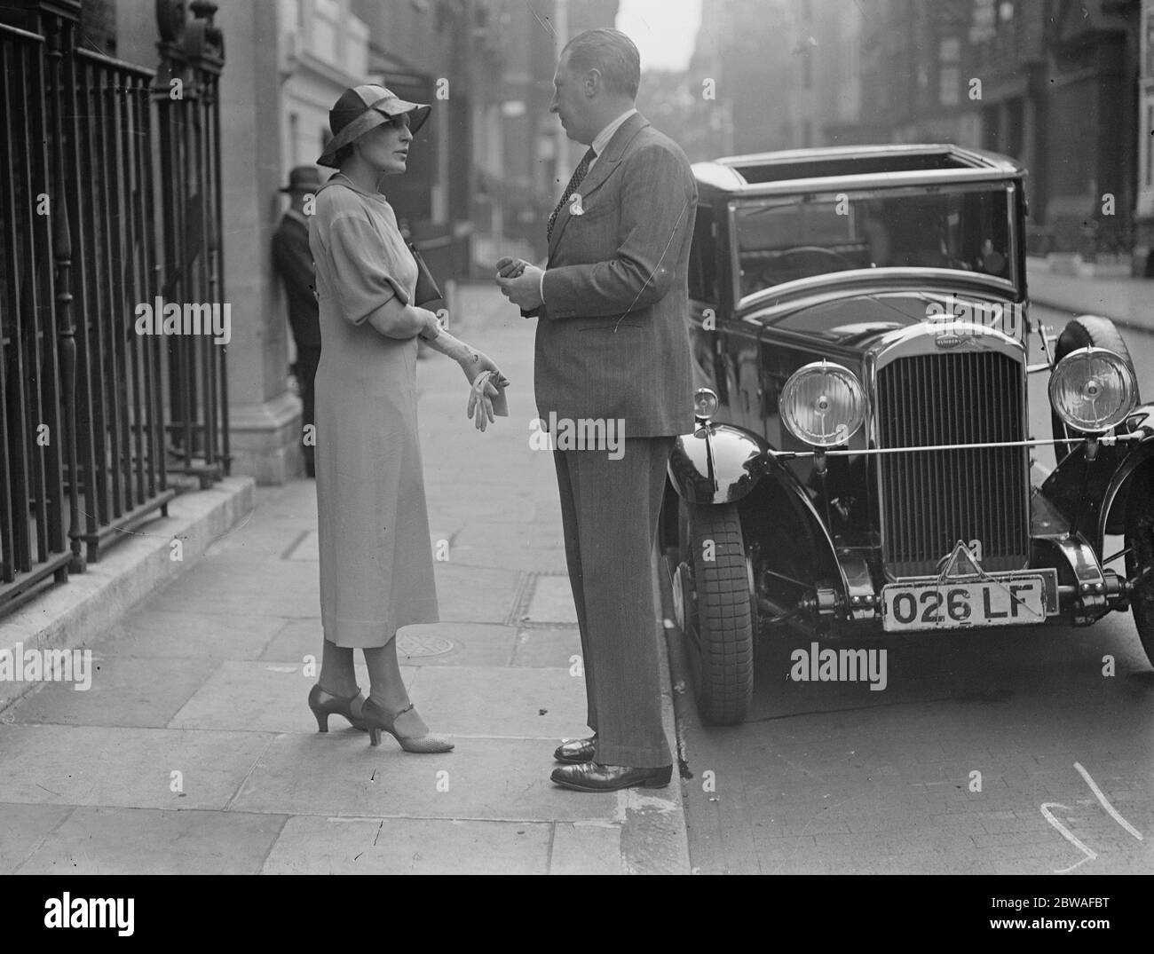 After the christening of of the infant son of Lord and Lady Aberconway at St Stephen ' s Chapel , House of Commons , London , Mrs WG Constable talks to Mr Osbert Sitwell . Personalities 3 July 1934 Stock Photo