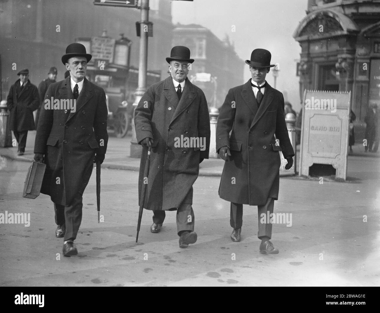 As they walk to the Houses of Parliament , Mr Arthur Henderson , MP , the Home Secretary ( centre ) , is flanked by his two sons who are both MPs themselves , Mr William Henderson, MP ( left ) and Mr Arthur Henderson Junior , MP . It is expected that when the Home Secretary takes his seat in the House of Commons today he will be introduced to the Speaker by both his sons , the first time that this has happened . 3 March 1924 Stock Photo